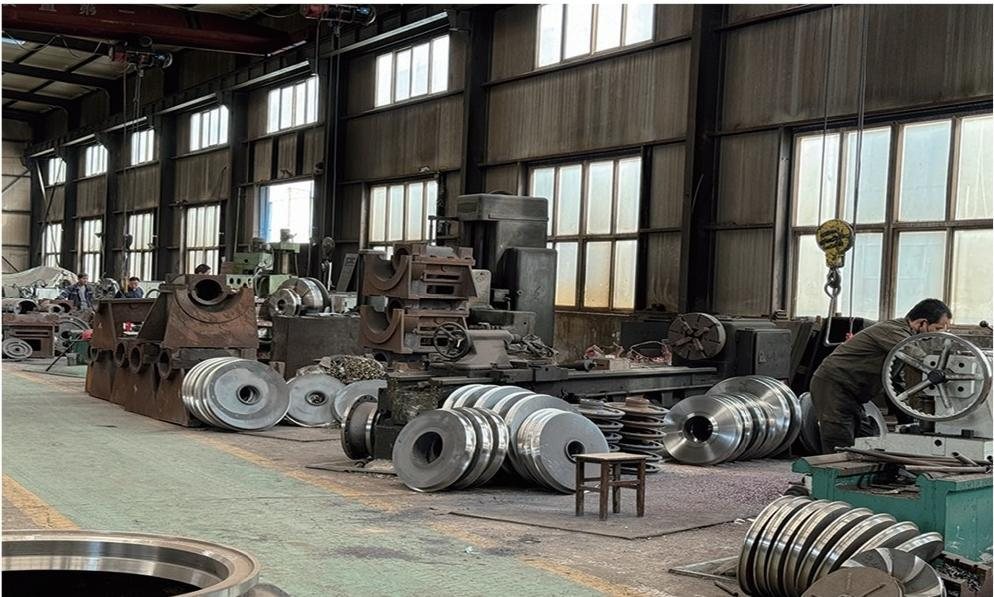 Machining bay at the Hebei Gaoxin Pump Industry works, with cast pump volutes on the floor